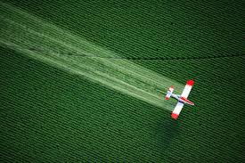 crop dusting streak and plane